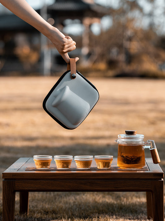This is a glass teapot travel set