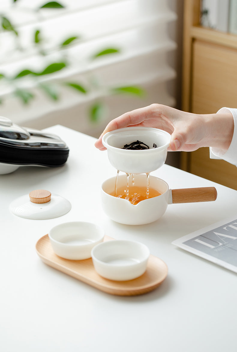 This is a ceramic teapot travel set
