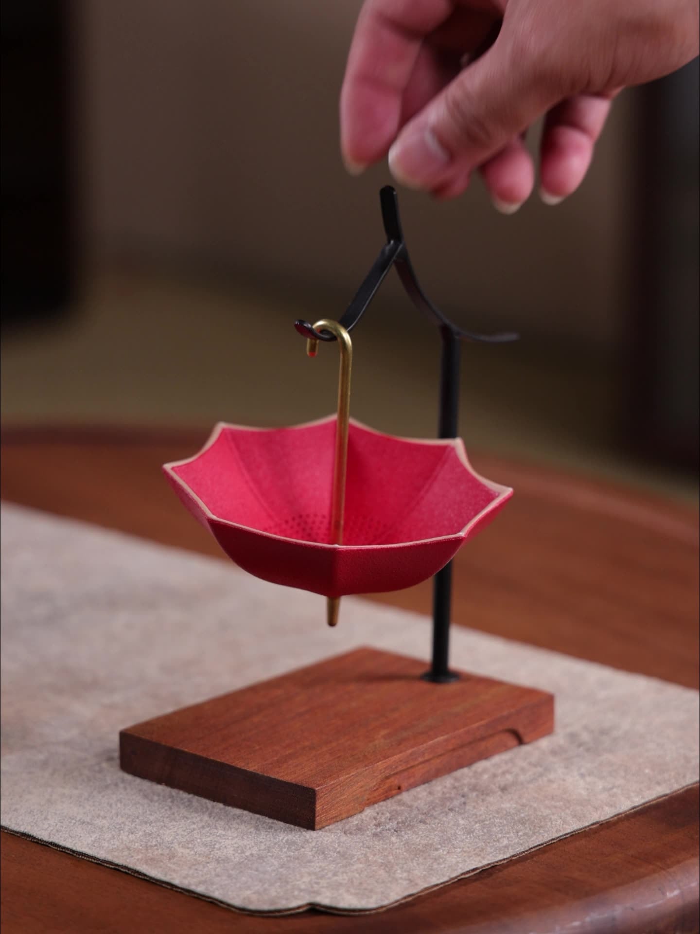 This is a ceramic umbrella shape tea filter tea strainer