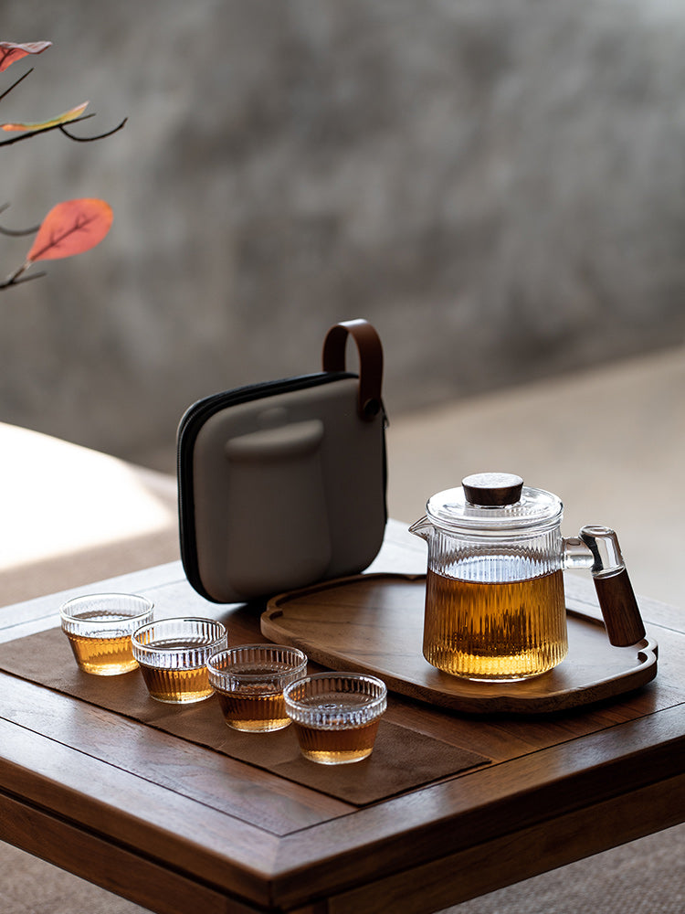 This is a glass teapot travel set