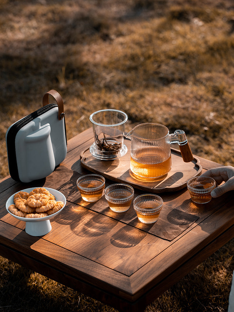 This is a glass teapot travel set