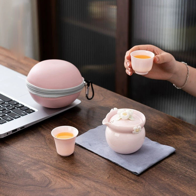 This is a ceramic teapot travel set