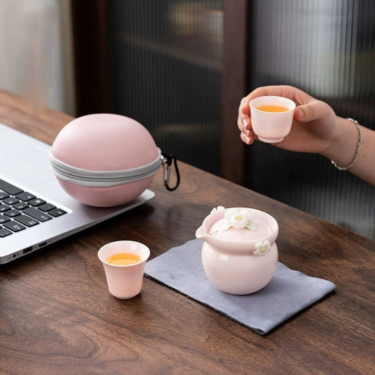 This is a ceramic teapot travel set