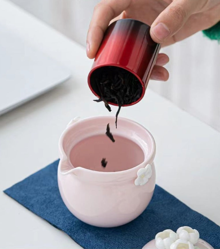 This is a ceramic teapot travel set