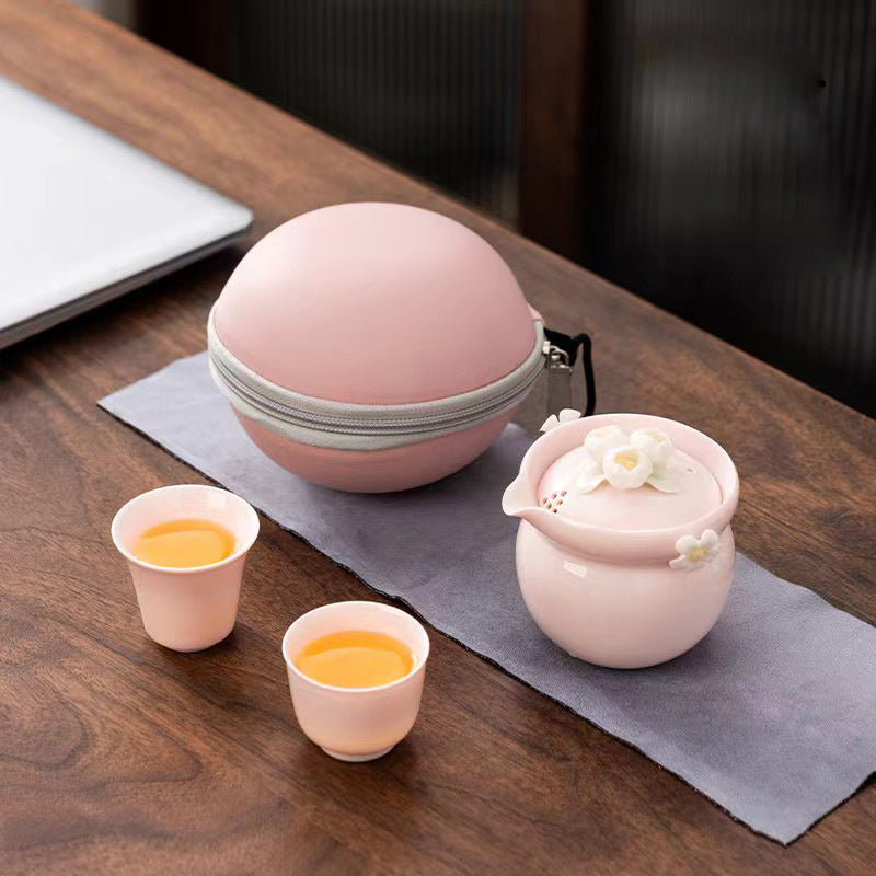 This is a ceramic teapot travel set