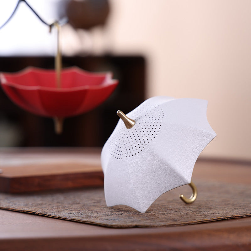 This is a ceramic umbrella shape tea filter tea strainer
