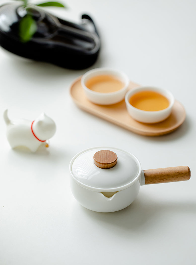 This is a ceramic teapot travel set
