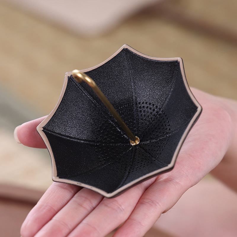 This is a ceramic umbrella shape tea filter tea strainer
