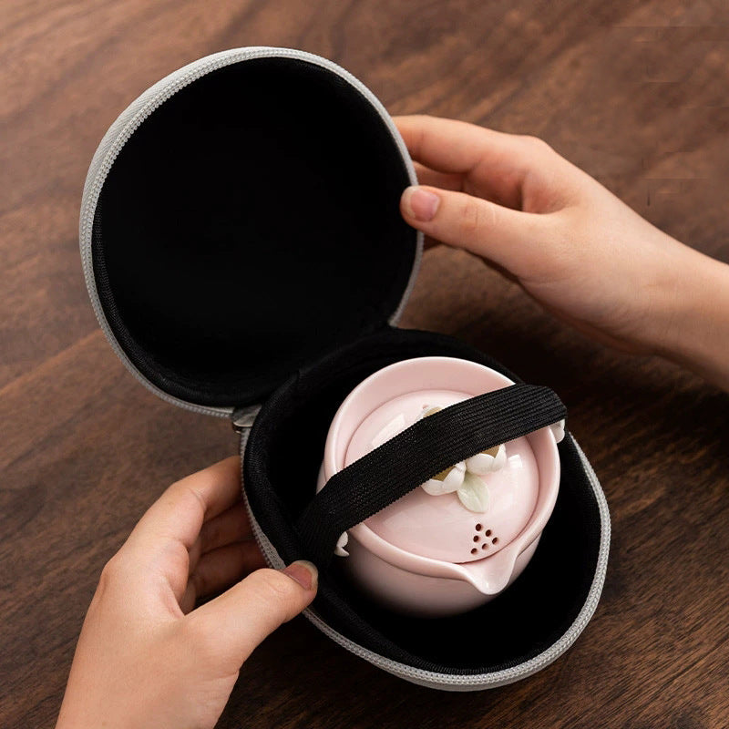 This is a ceramic teapot travel set