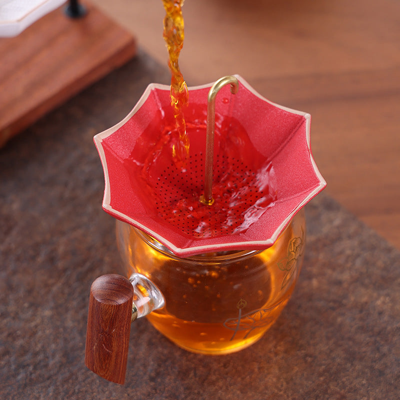 This is a ceramic umbrella shape tea filter tea strainer