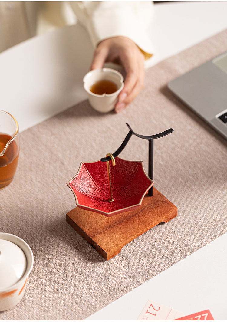 This is a ceramic umbrella shape tea filter tea strainer