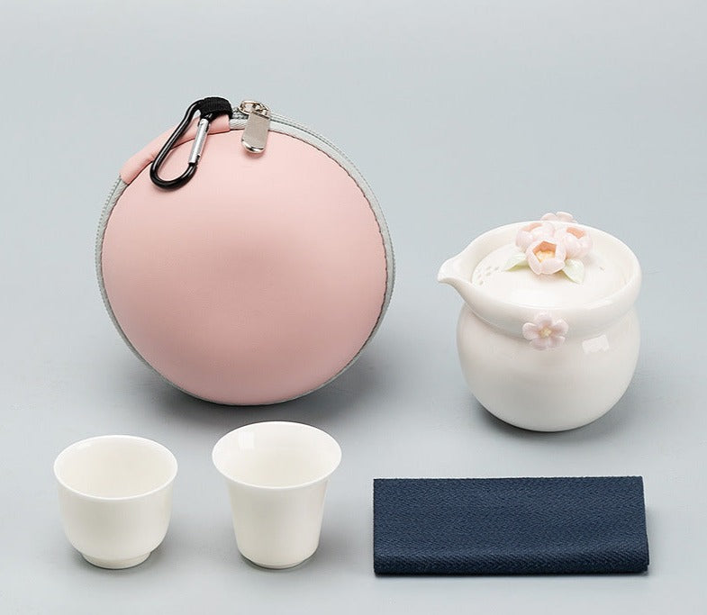 This is a ceramic teapot travel set