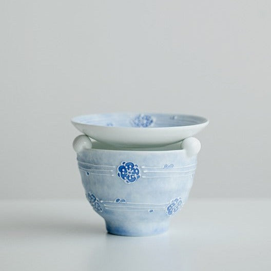 This is a ceramic scoop warmer set