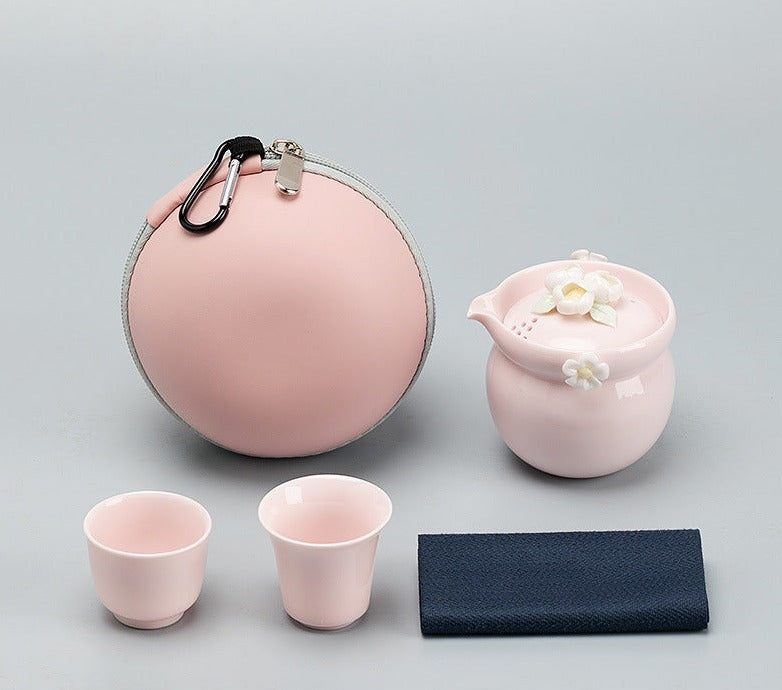 This is a ceramic teapot travel set