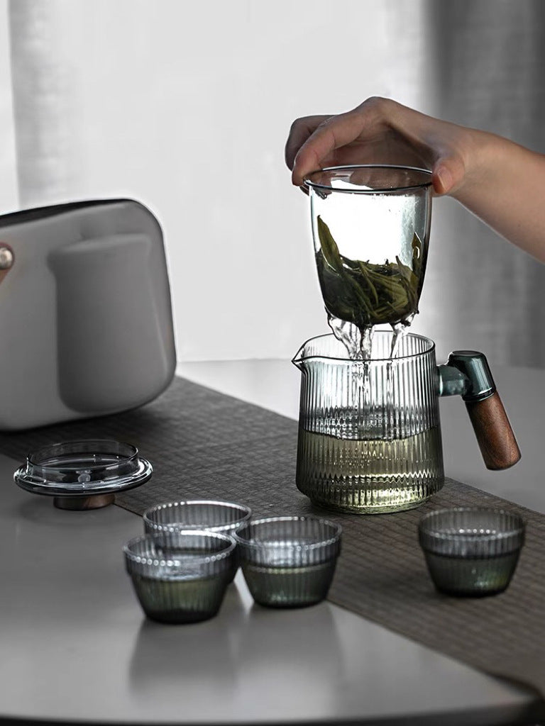 This is a glass teapot travel set