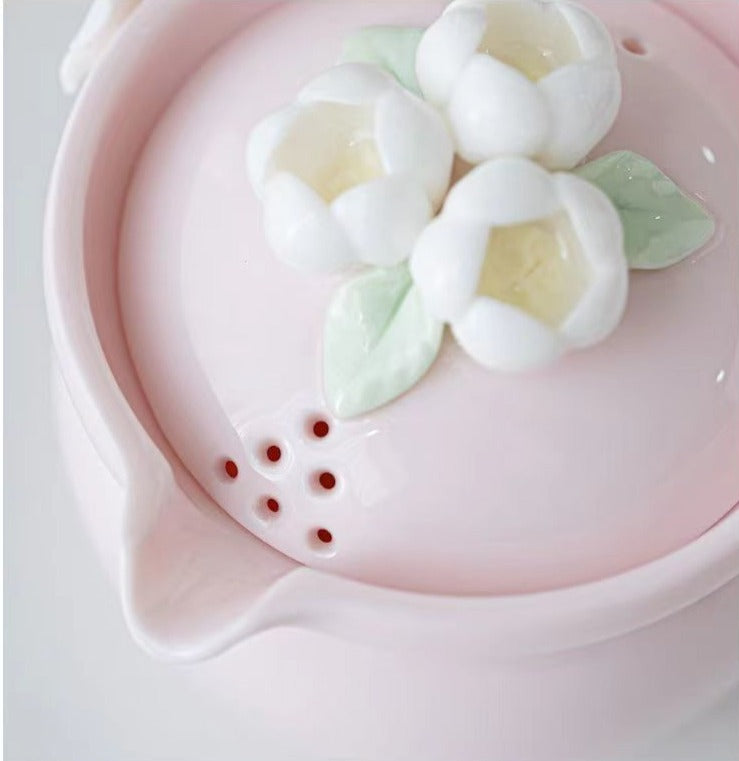 This is a ceramic teapot travel set