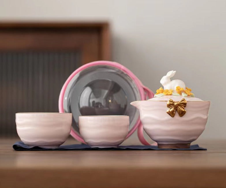 This is a ceramic teapot travel set