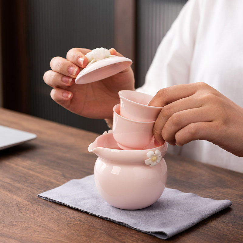 This is a ceramic teapot travel set