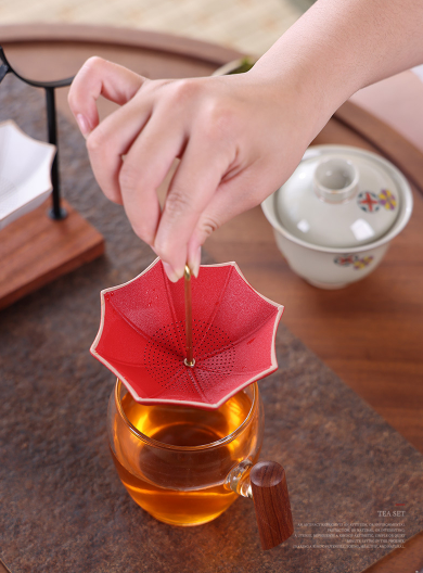 This is a ceramic umbrella shape tea filter tea strainer