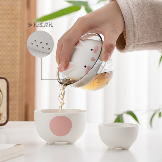This is a ceramic teapot travel set