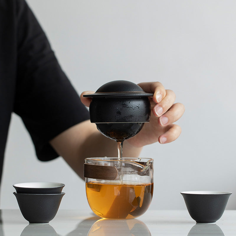 This is a glass teapot travel set