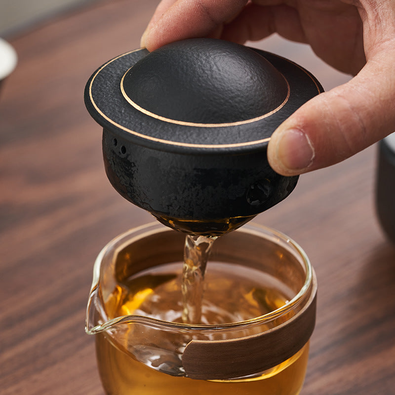 This is a glass teapot travel set