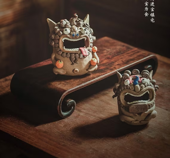This is a pottery teapet incense holder