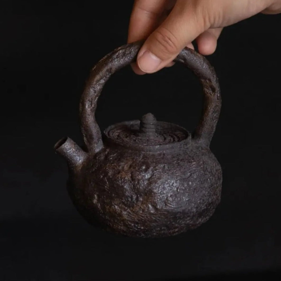 This is a pottery lifting handle kettle