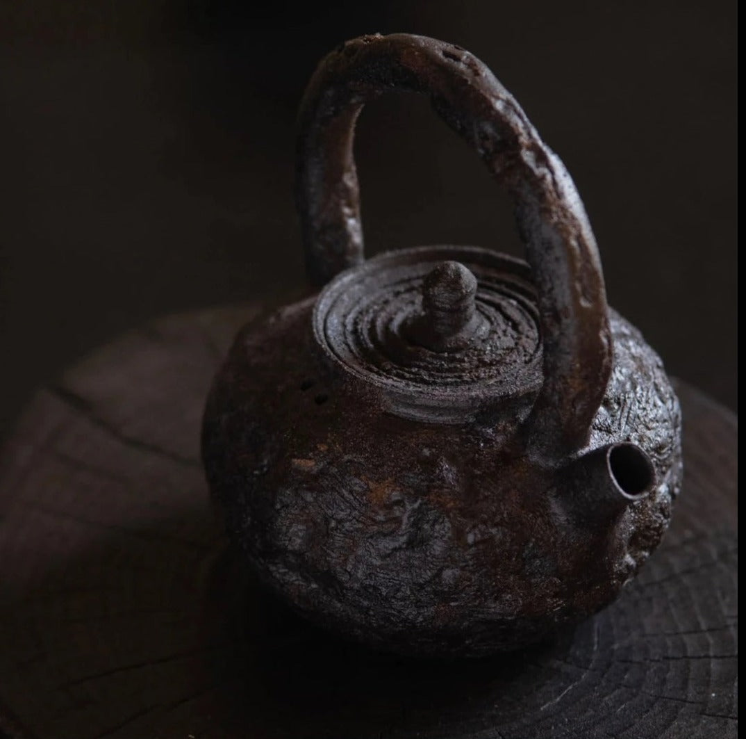 This is a pottery lifting handle kettle