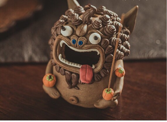 This is a pottery teapet incense holder