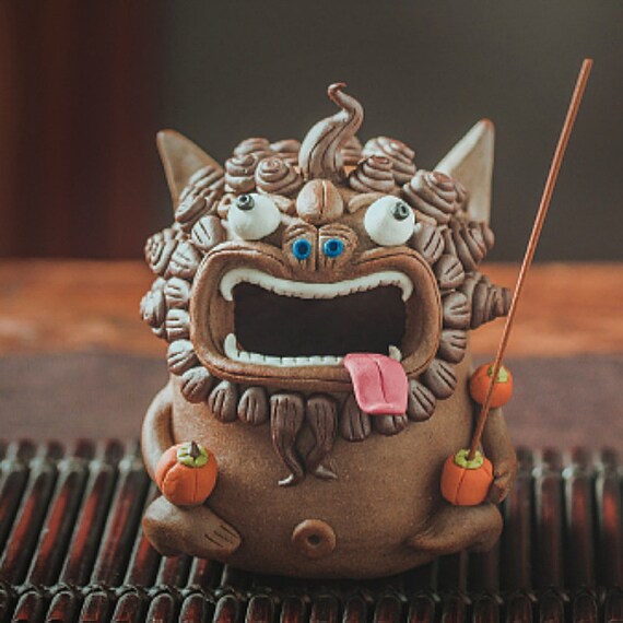 This is a pottery teapet incense holder