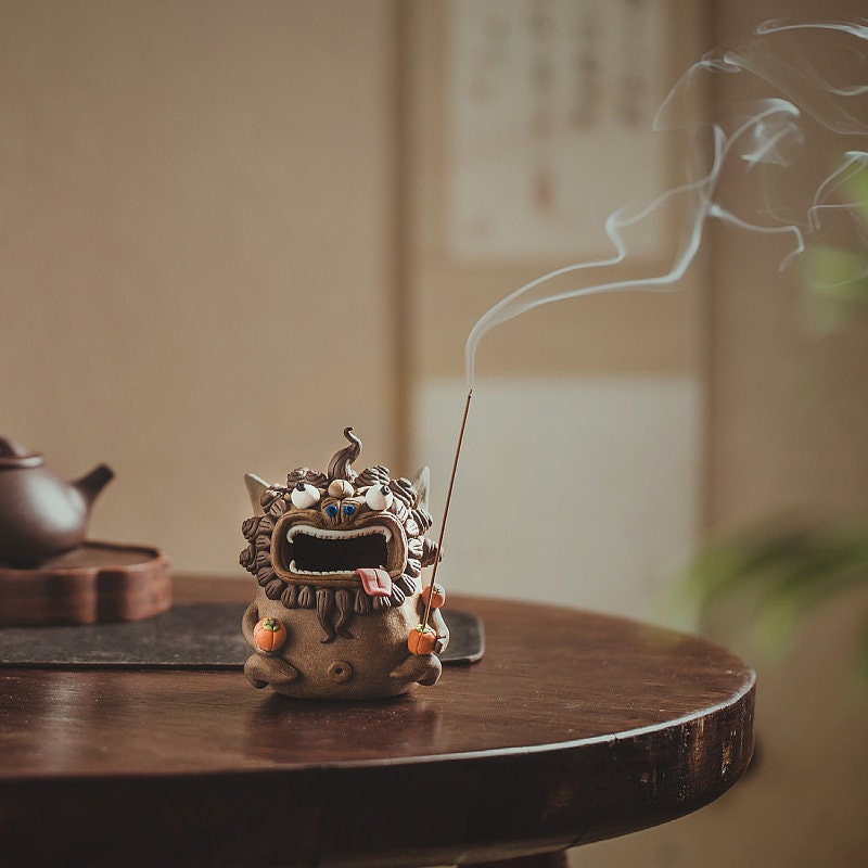 This is a pottery teapet incense holder
