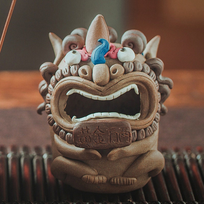 This is a pottery teapet incense holder