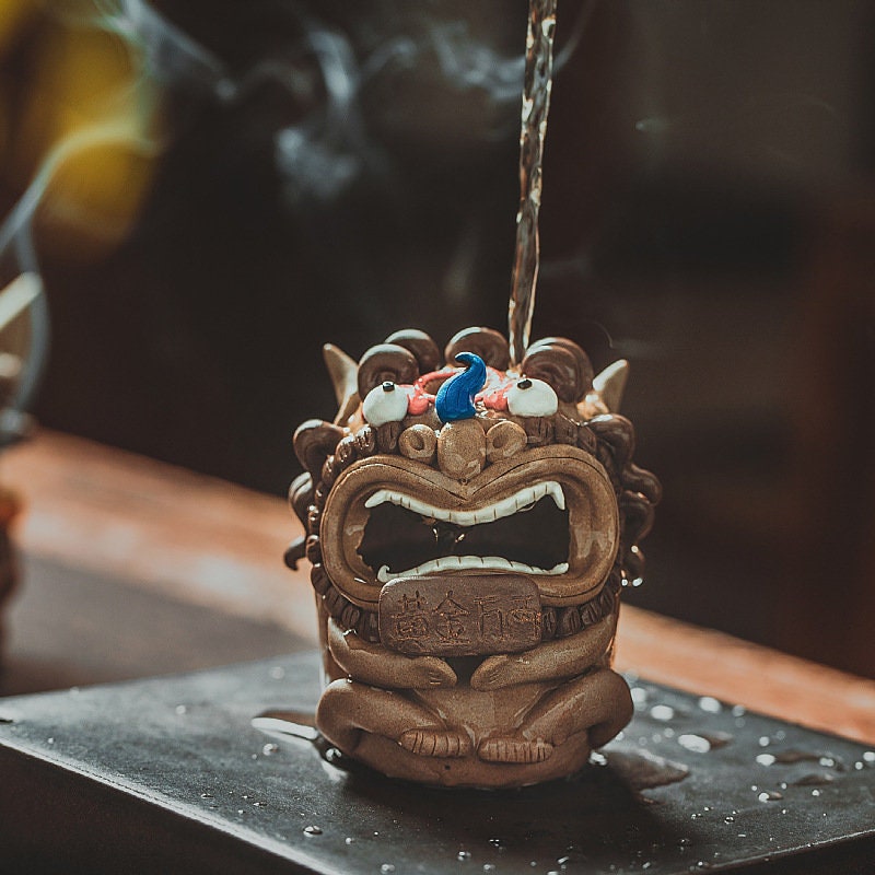 This is a pottery teapet incense holder