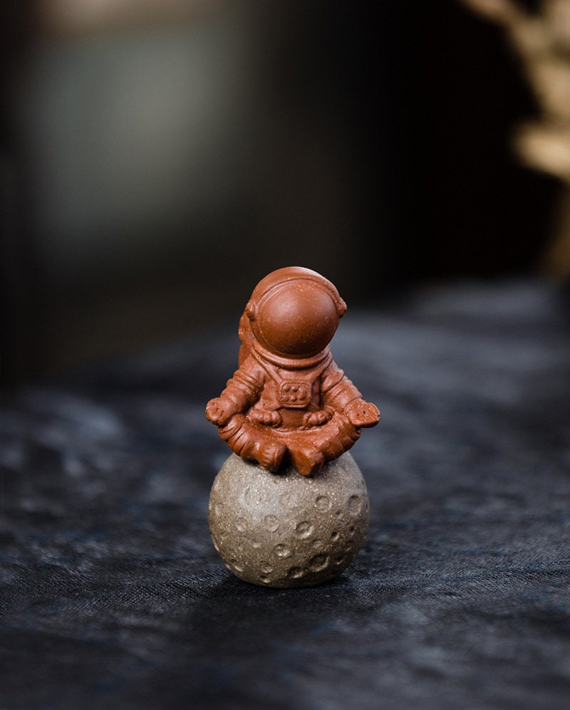 This is a Yixing purple clay meditation astronaut teapet