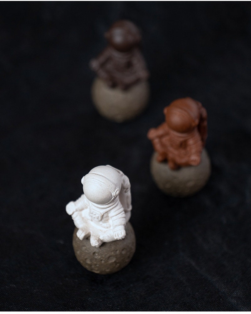 This is a Yixing purple clay meditation astronaut teapet