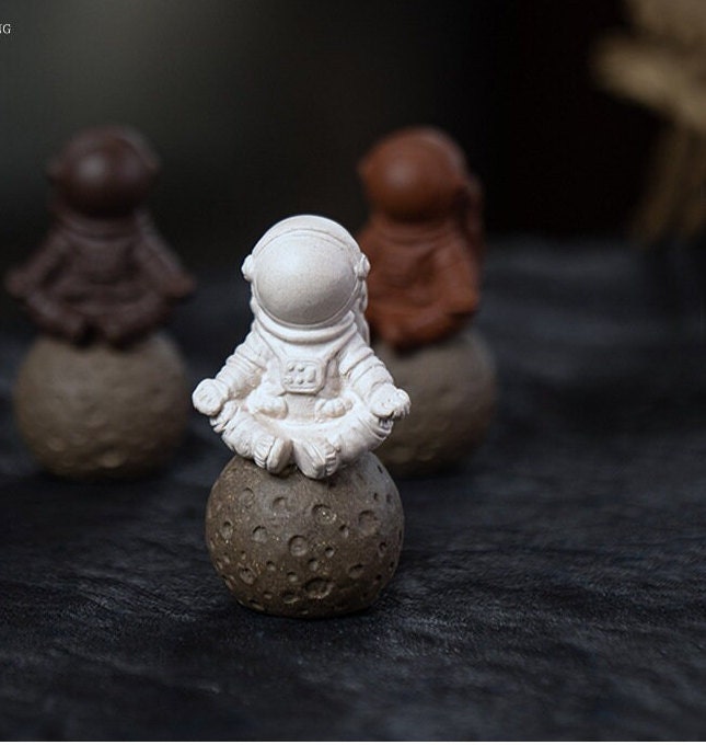 This is a Yixing purple clay meditation astronaut teapet