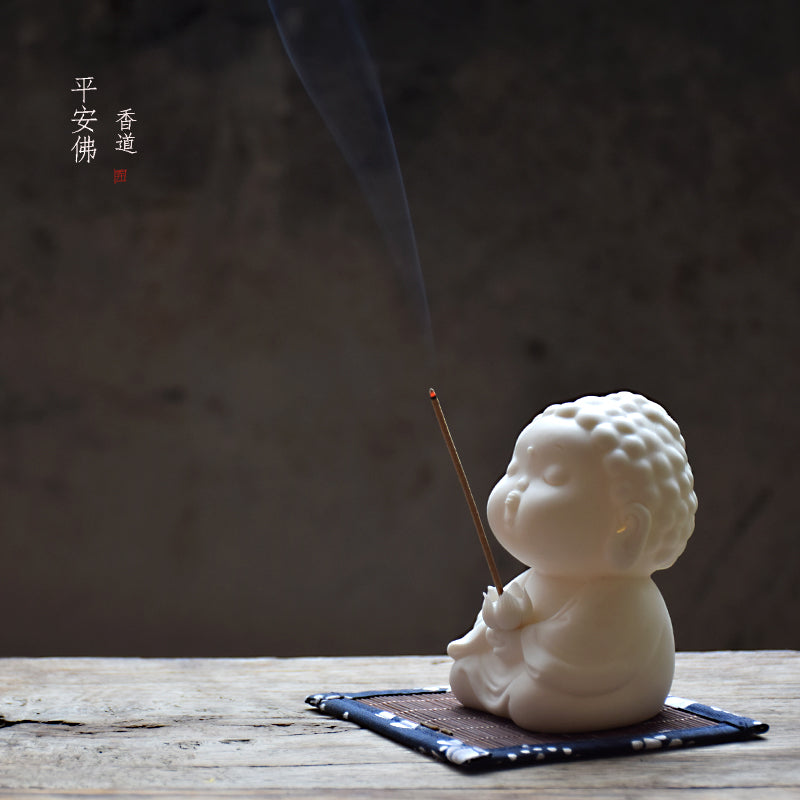 This is a white porcelain buddha teapet incense holder