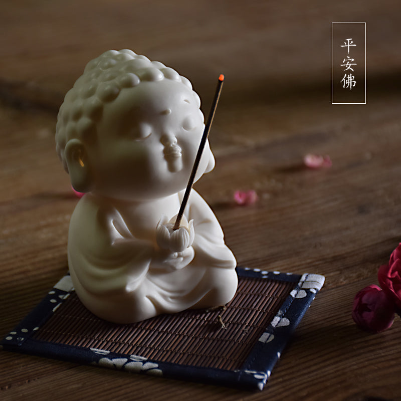 This is a white porcelain buddha teapet incense holder