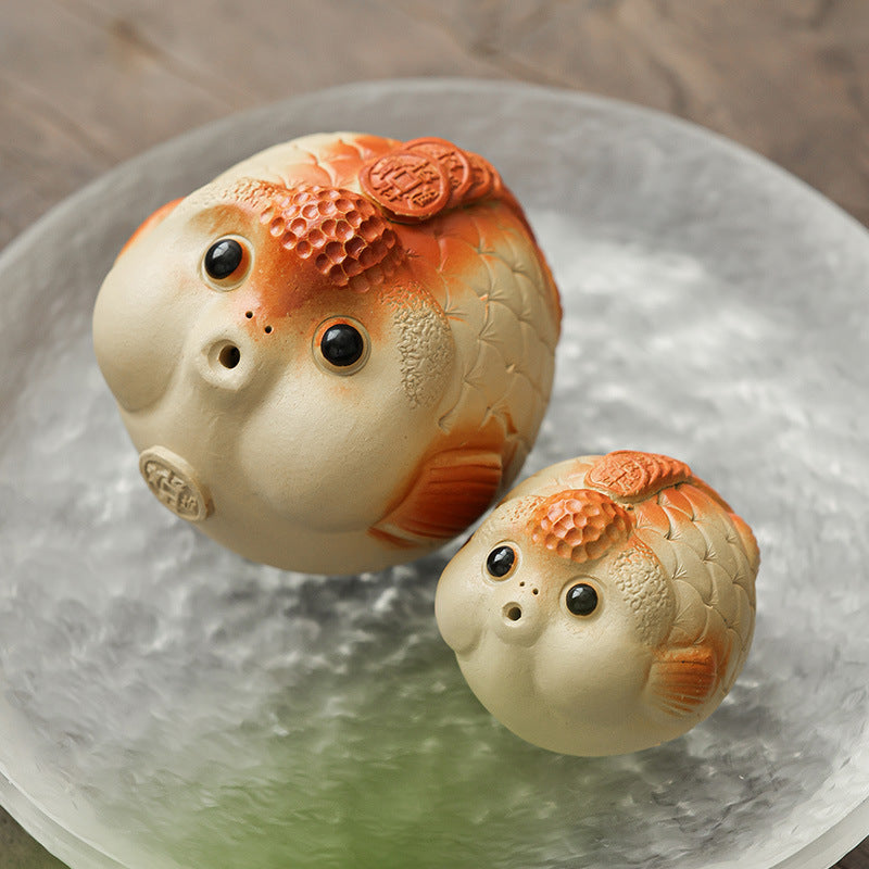 This is a Yixing purple clay bubble fish teapet