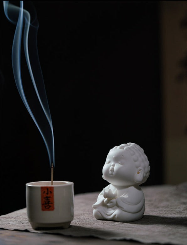 This is a white porcelain buddha teapet incense holder