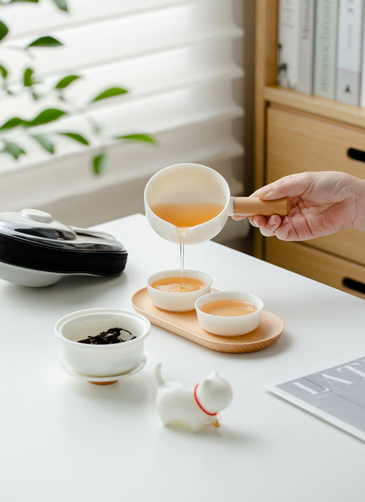 This is a ceramic teapot travel set