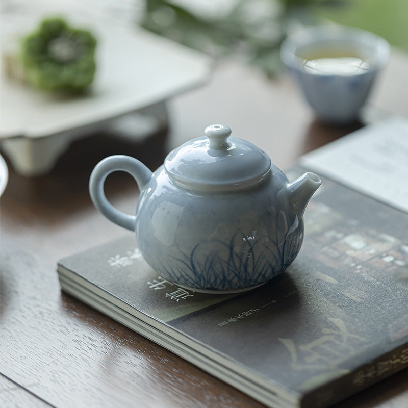 this is a ceramic teapot. this is a blue teapot