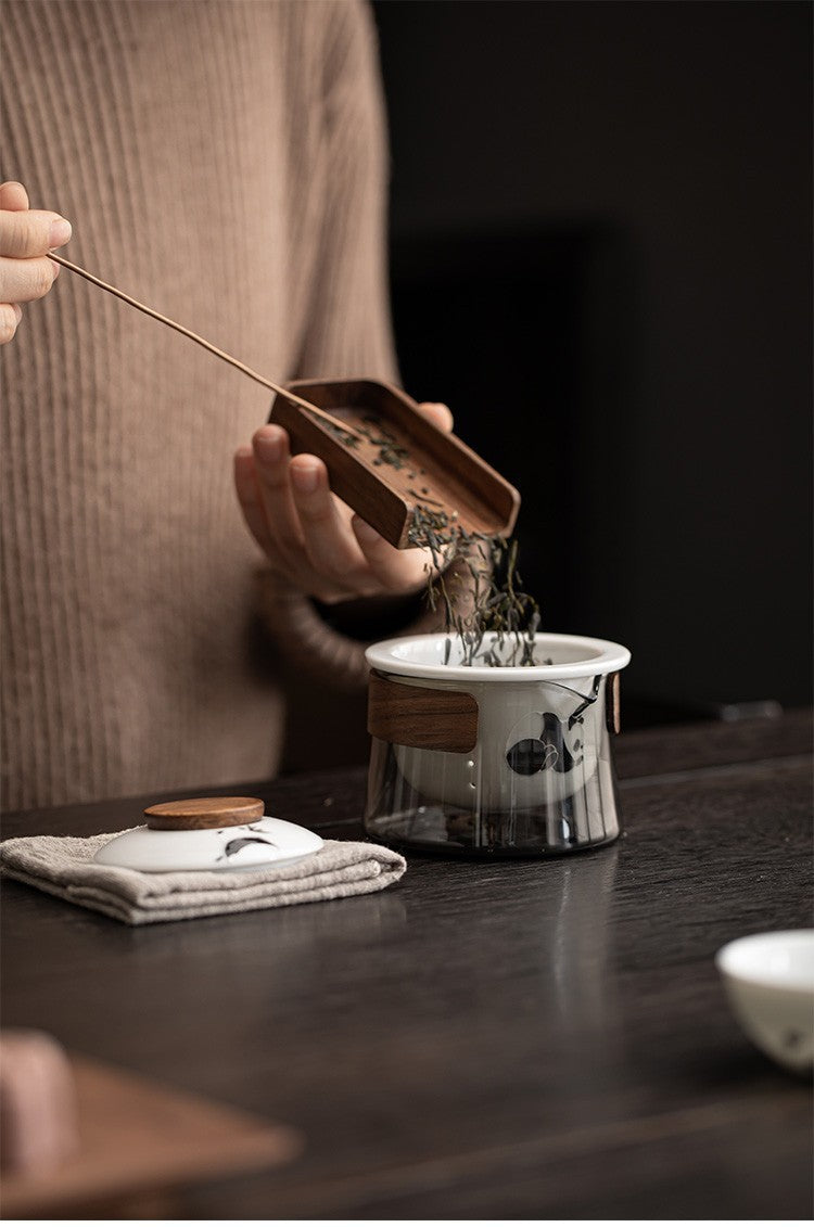 This is a ceramic teapot travel set