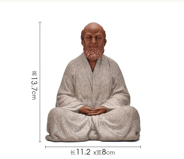 this is a pottery mini bodhidharma sculpture