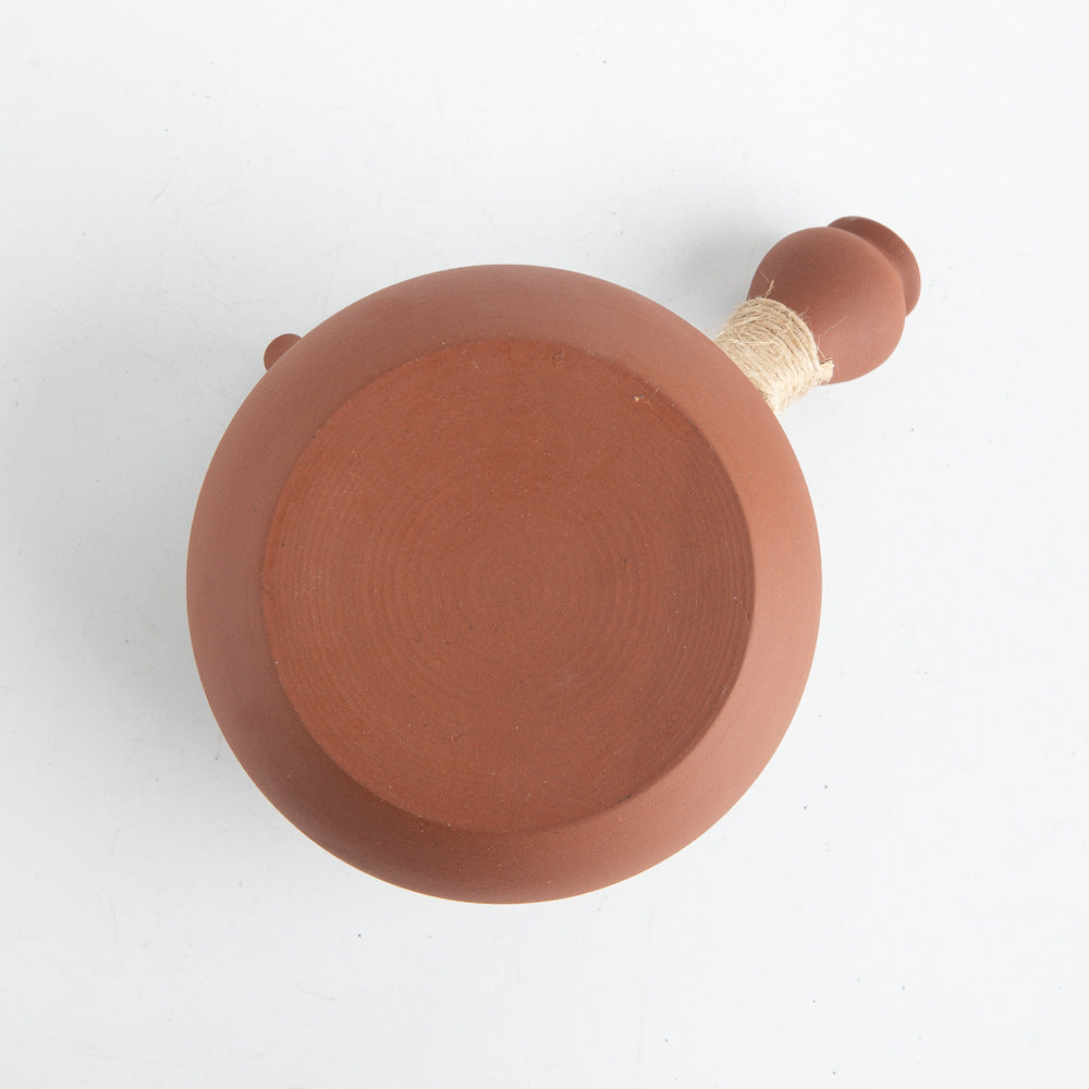 This is a pottery side handle kettle