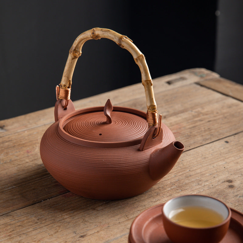 This is a pottery side handle kettle