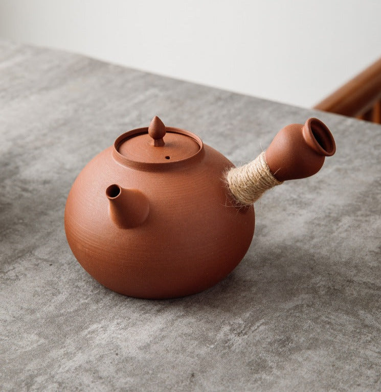 This is a pottery side handle kettle