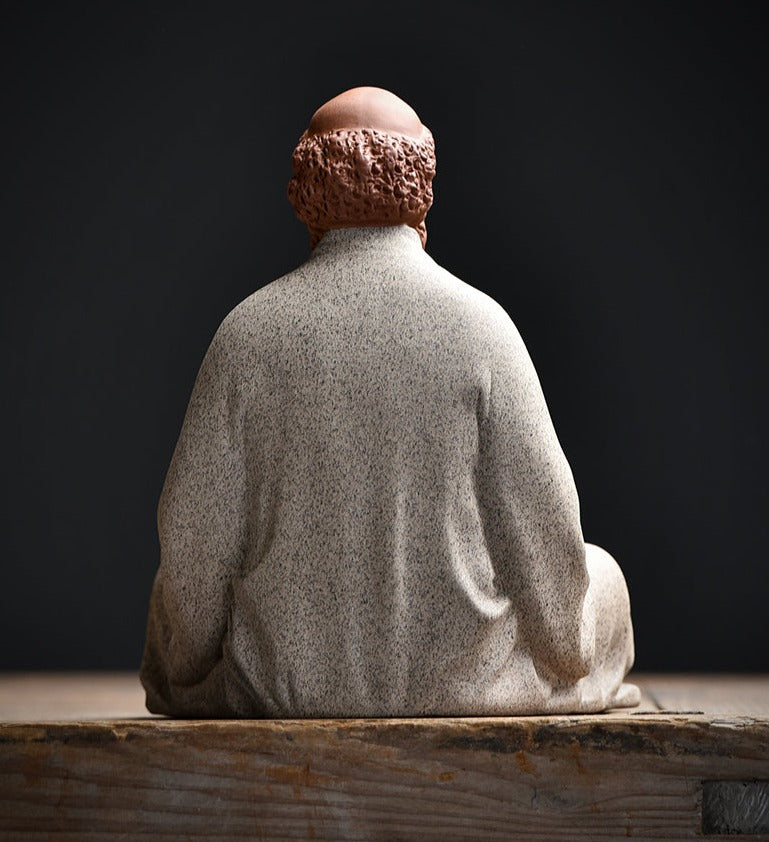 this is a pottery mini bodhidharma sculpture