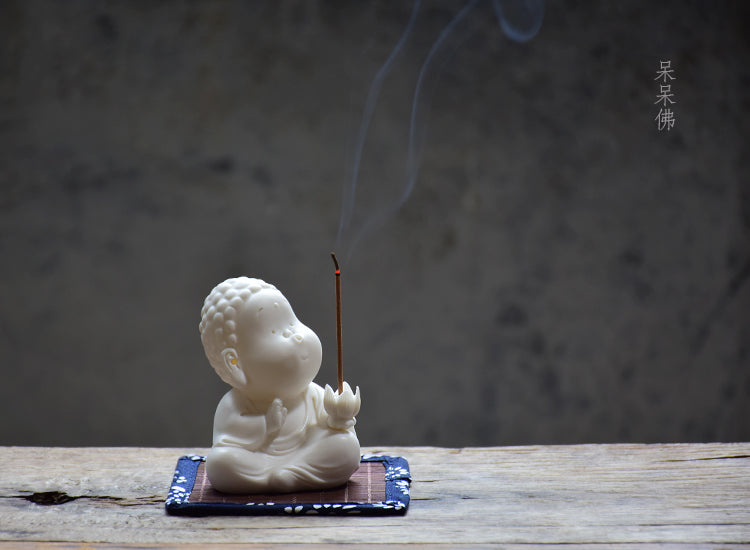 This is a white porcelain buddha teapet incense holder